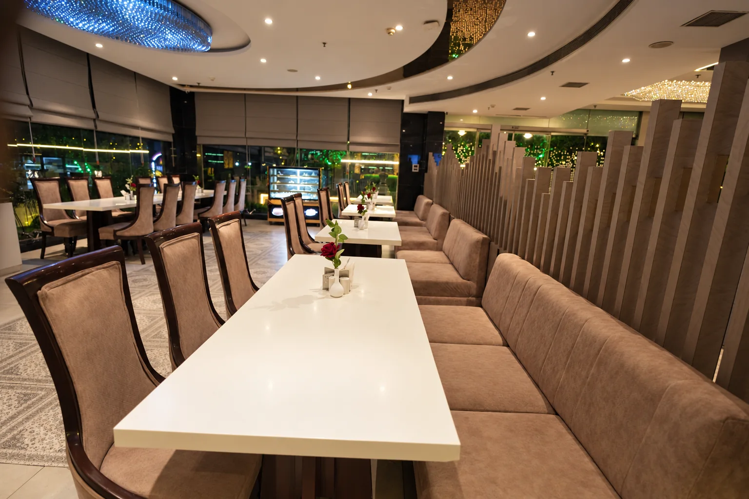 Dining tables with sofa seating at Hotel Ranbirs restaurant