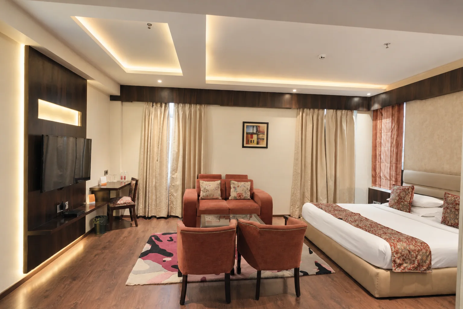 Guest room interior with television and sitting area at Hotel Ranbirs
