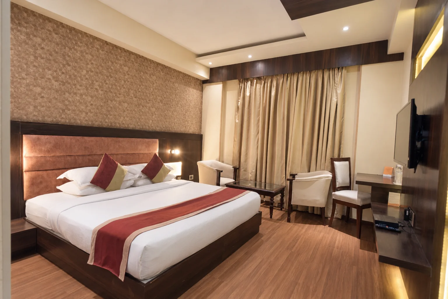 Guest room with bed, seating and work desk at Hotel Ranbirs